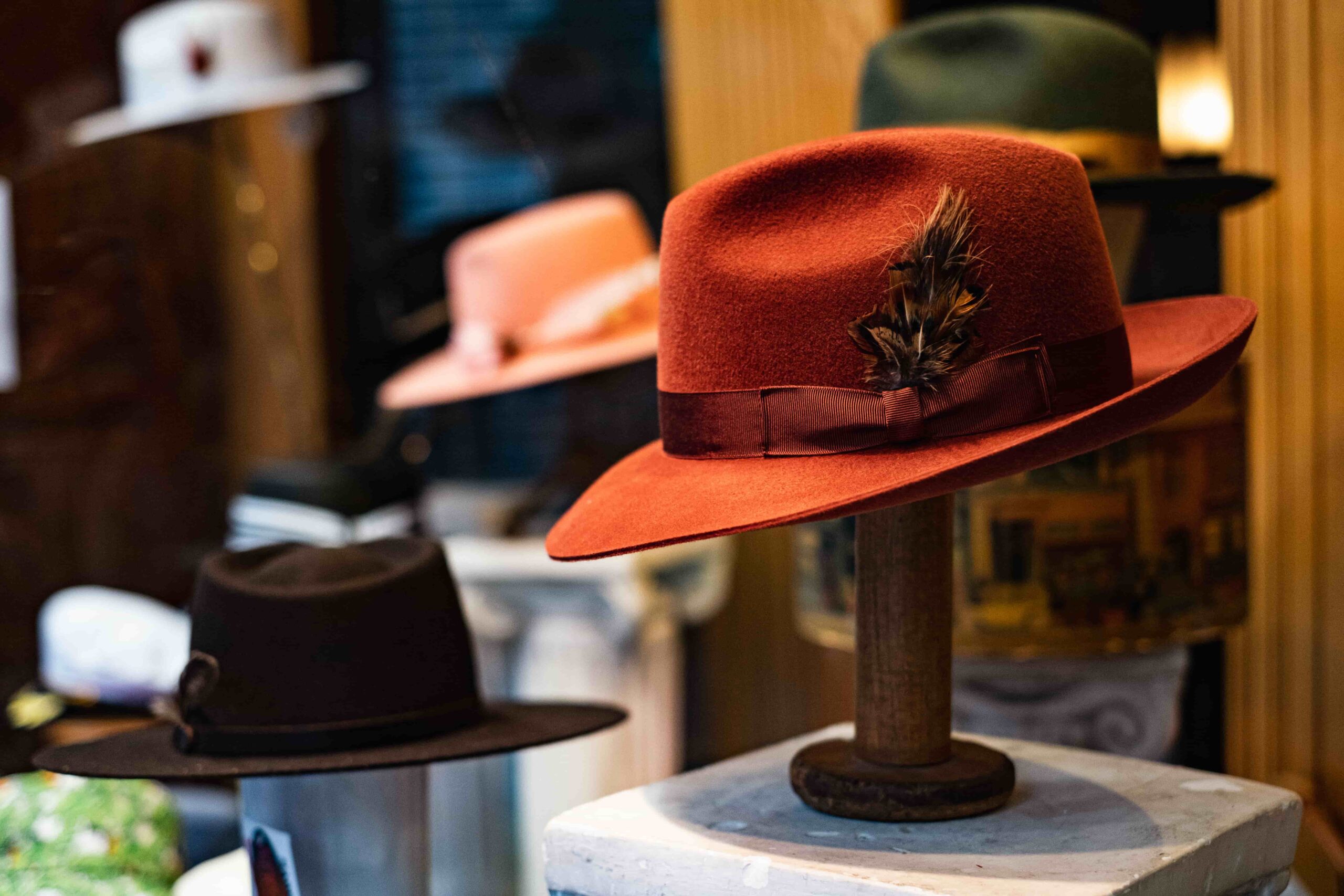 Various types and colors of hats are displayed for customers to choose from.