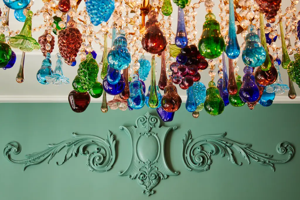 A beautiful, multicolored glass chandelier hangs from the ceiling.