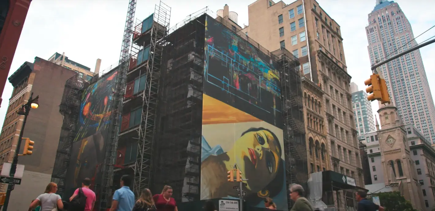 A woman's image is displayed on the building's billboard.