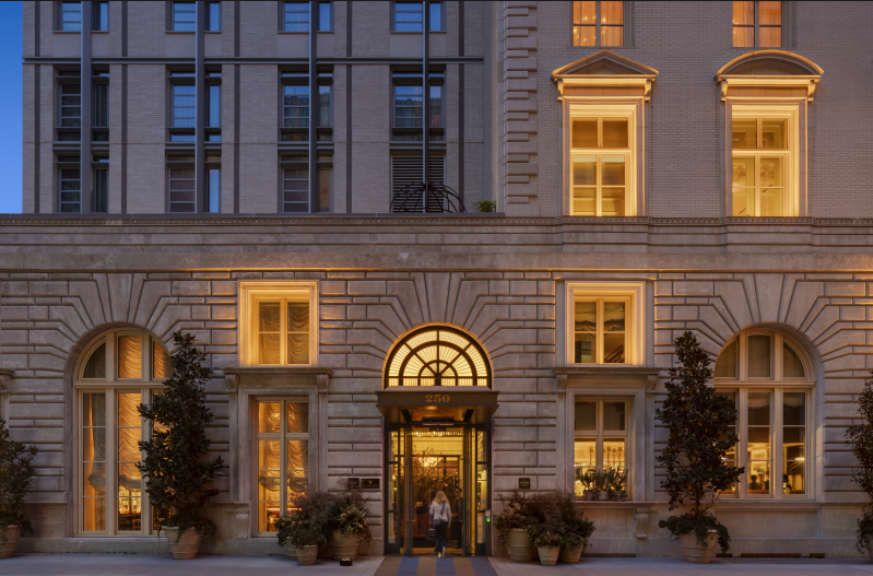 Luxury hotel exterior on Fifth Avenue with illuminated windows and grand entrance